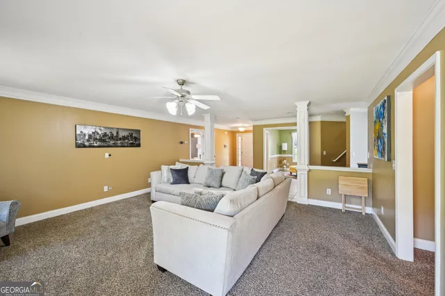 a living room with furniture and a chandelier