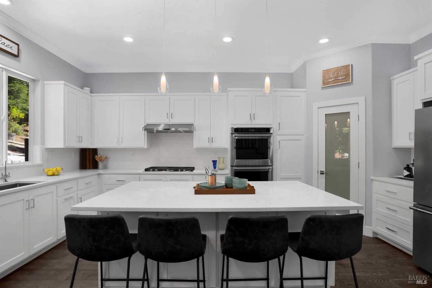 5909 Featherlight Place Santa Rosa, CA 95409 - Photo 2 of 50 Gourmet Kitchen: Chef’s dream featuring quartz countertops, upgraded appliances that include dual oven, built-in microwave, and gas stove top, along with a filtered instant 190° water system.