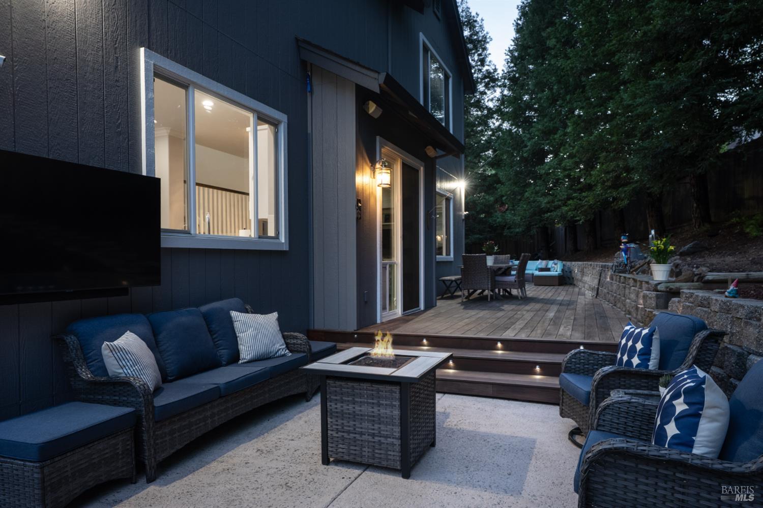 5909 Featherlight Place Santa Rosa, CA 95409 - Photo 43 of 50 Deck Lighting: Evening ambiance with integrated LED step and retaining wall lighting for seamless indoor-outdoor entertaining.