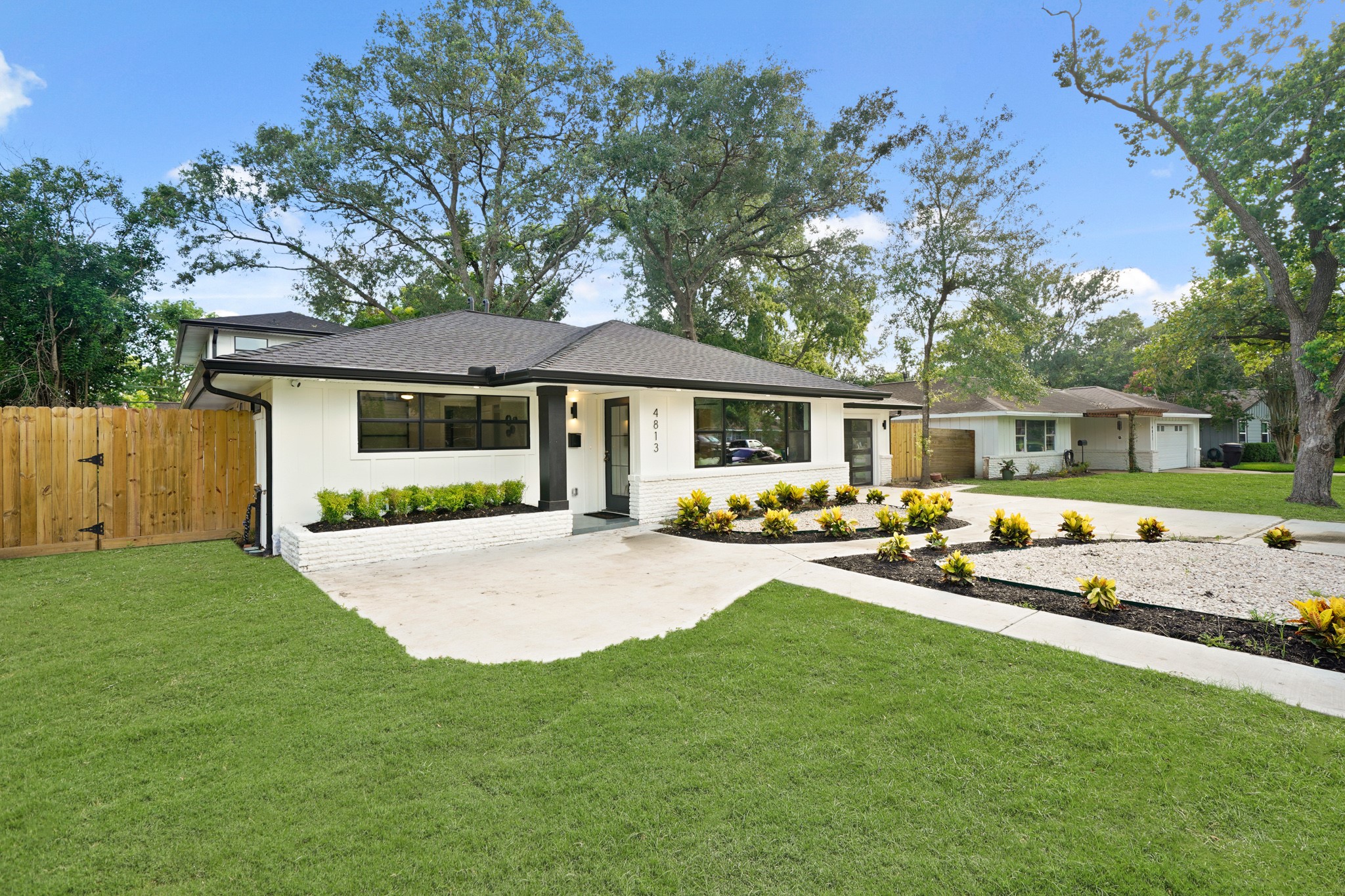 4813 Hummingbird Street Houston, TX 77035 - Photo 3 of 50 Guests are Greeted by a Convenient Cement Path from the Driveway to the Front Sidewalk. The Inviting Front Porch (Approximately 4'8" x 4'8") features Large Format Grey Tile, Black Contemporary Style Tube-Shaped Light, and a Black Metallic Mailbox. The Front Yard offers a Recently Poured Double Wide Driveway leading to a 2 Car Attached Garage. The House also features Gutters with Leaf Guards, French Drains, and a Newly Installed Sprinkler System.