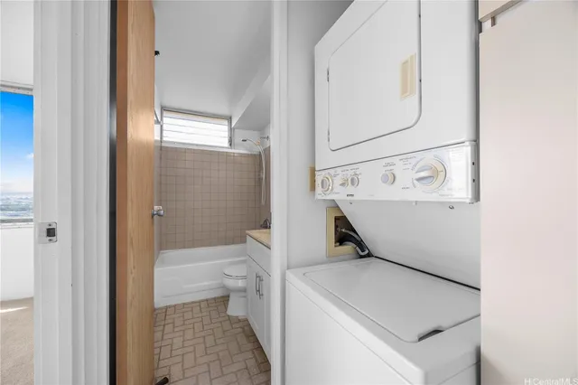 a bathroom with a granite countertop sink a toilet and bathtub