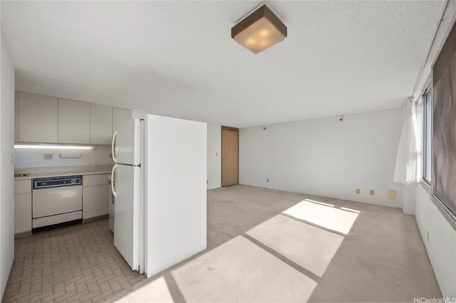 a view of a kitchen with a sink a stove top oven and refrigerator