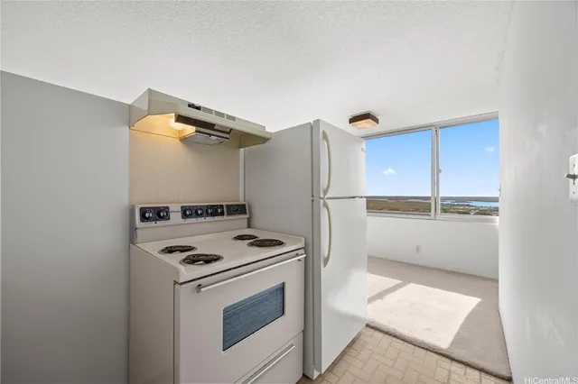 a kitchen with a stove and a refrigerator