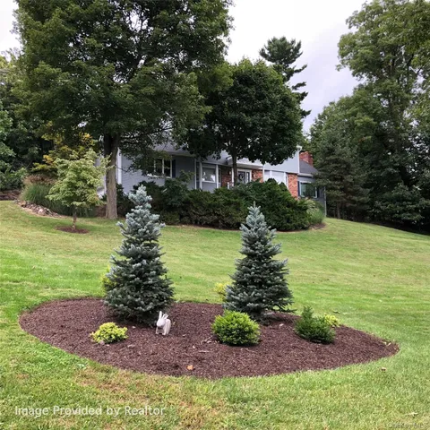 a view of a garden with a house