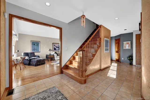 a living room with furniture and a dining table
