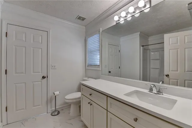 an empty room with closet and windows