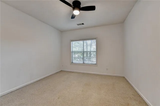 a view of an empty room and a window
