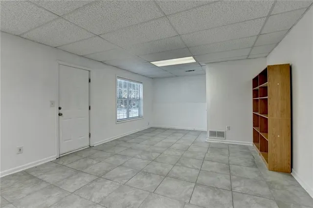 a view of a house with backyard and trees