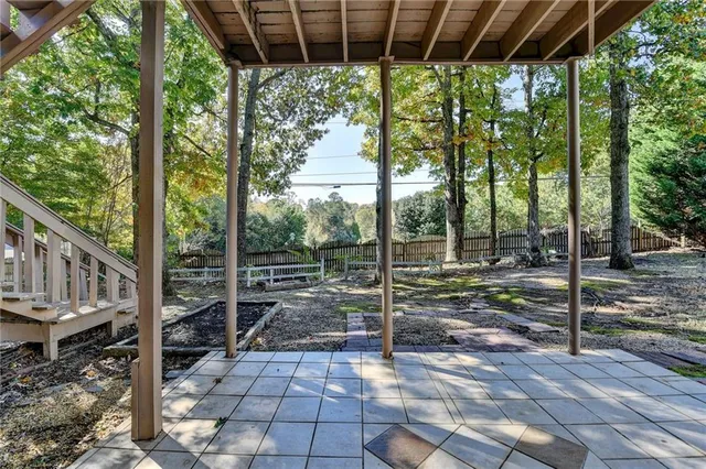a view of balcony with wooden floor and fence