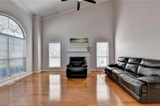 a living room with furniture a fireplace and a large window