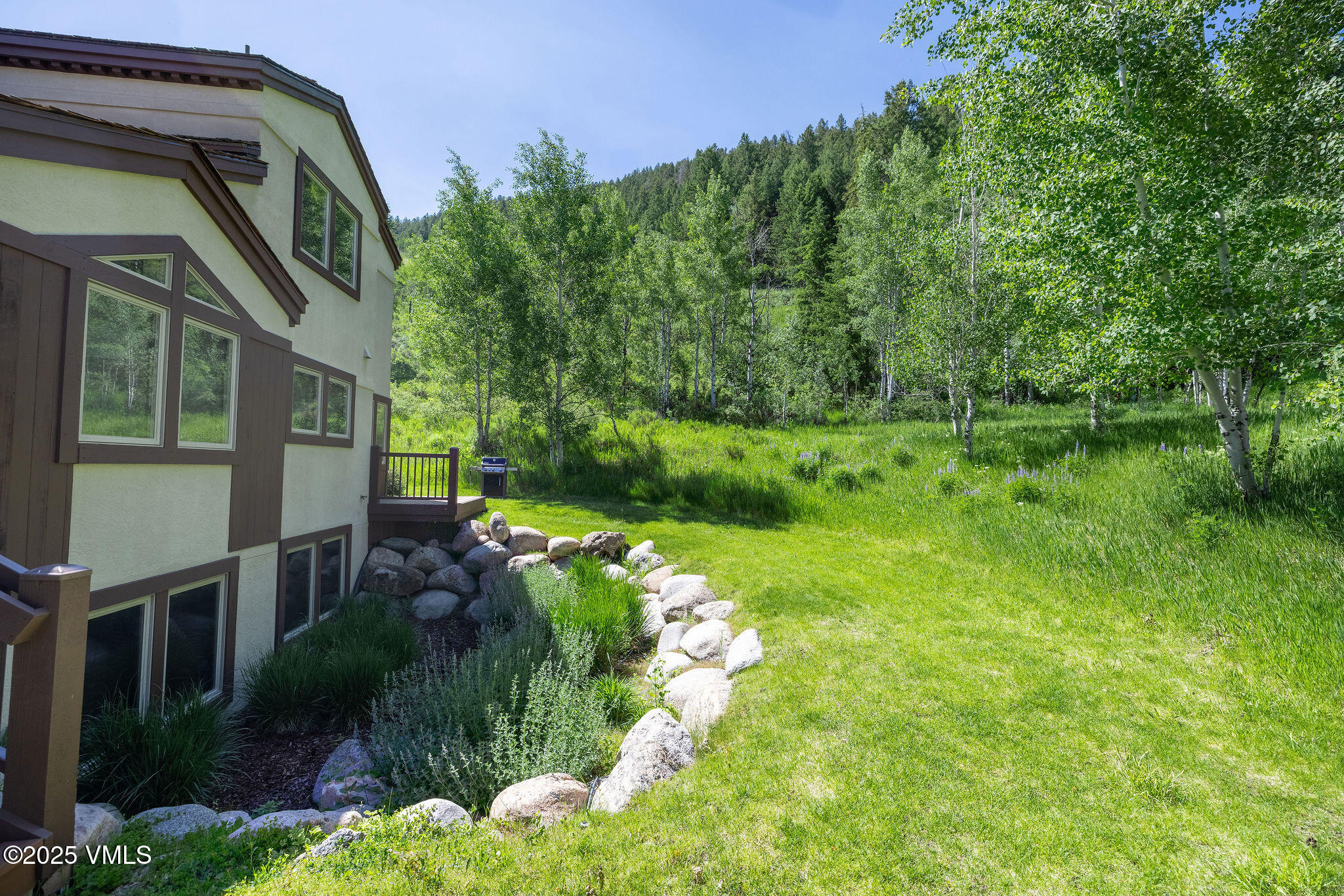 51 Hillside Court Edwards, CO 81632 - Photo 34 of 39 a backyard of a house with a yard and outdoor seating