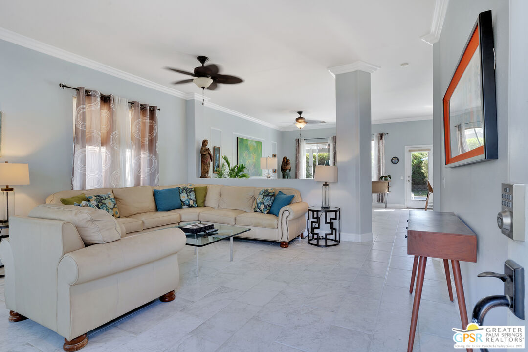 68315 Riviera Road Cathedral City, CA 92234 - Photo 11 of 33 a living room with furniture and a large window