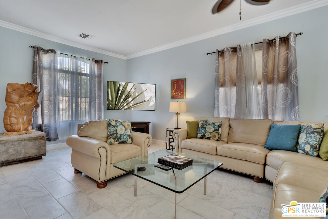 68315 Riviera Road Cathedral City, CA 92234 - Photo 12 of 33 a living room with furniture and a large window