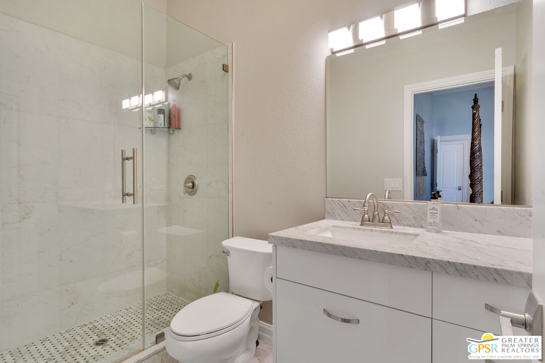 68315 Riviera Road Cathedral City, CA 92234 - Photo 19 of 33 a bathroom with a sink a toilet and shower
