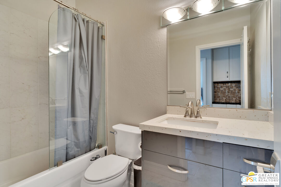 68315 Riviera Road Cathedral City, CA 92234 - Photo 21 of 33 a bathroom with a sink vanity mirror and toilet