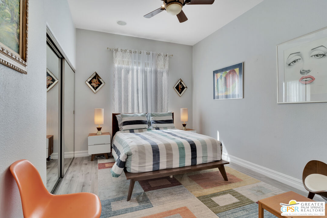 68315 Riviera Road Cathedral City, CA 92234 - Photo 22 of 33 a bedroom with a bed and wooden floor