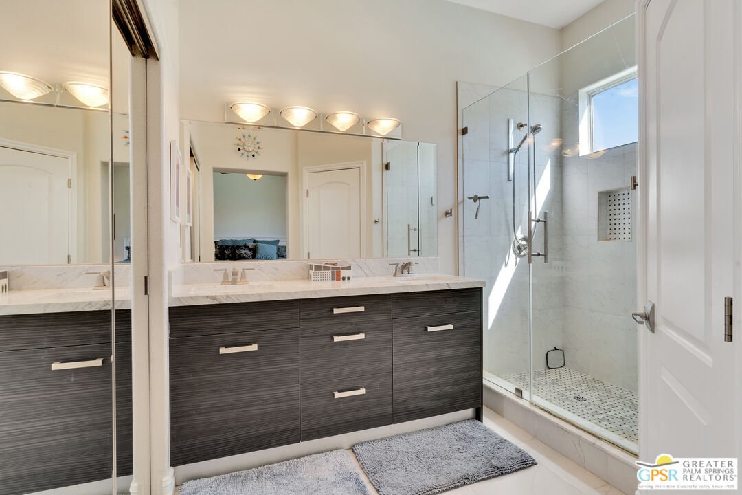68315 Riviera Road Cathedral City, CA 92234 - Photo 26 of 33 a bathroom with a tub shower sink and mirror