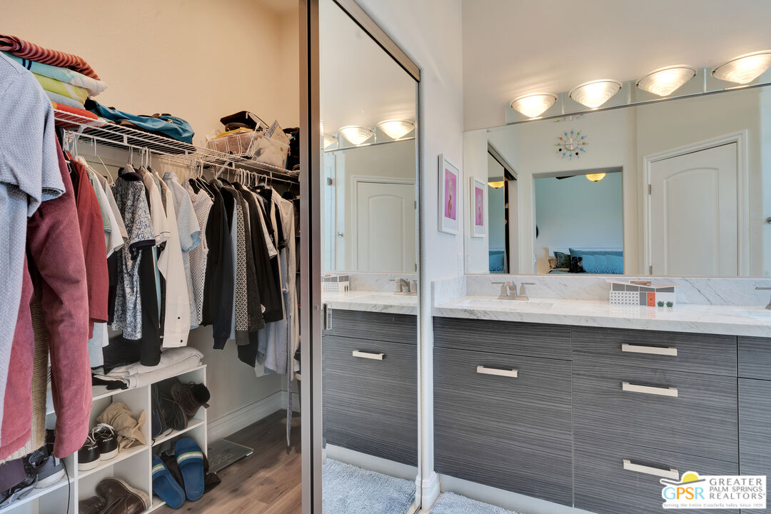 68315 Riviera Road Cathedral City, CA 92234 - Photo 28 of 33 a view of walk in closet with clothes and shoes