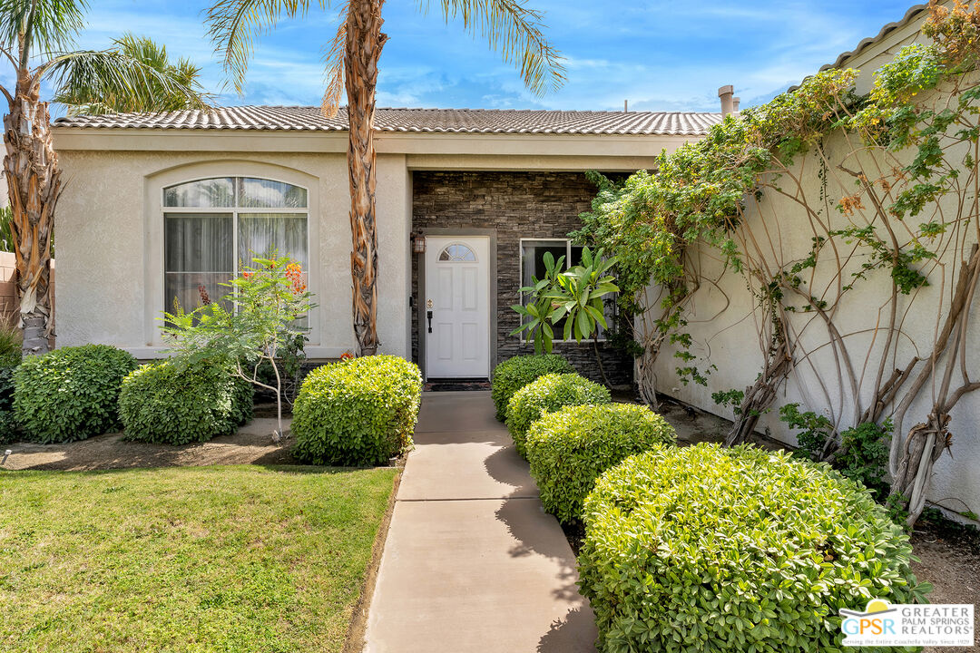 68315 Riviera Road Cathedral City, CA 92234 - Photo 3 of 33 a front view of a house with garden