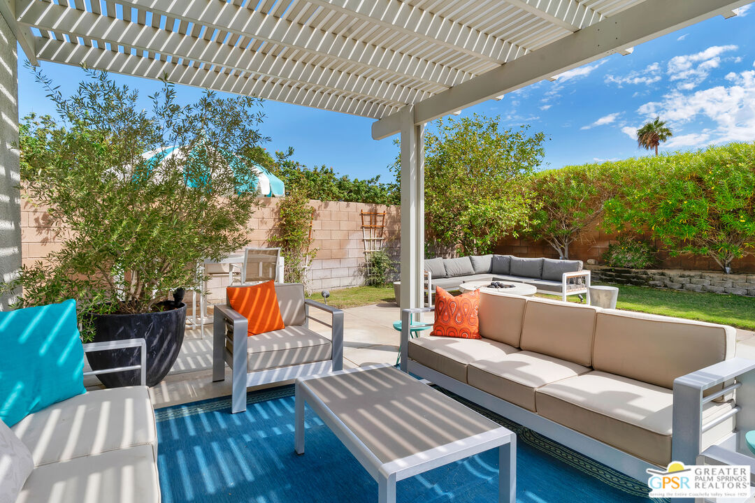 68315 Riviera Road Cathedral City, CA 92234 - Photo 4 of 33 a outdoor sitting area with furniture and wooden floor