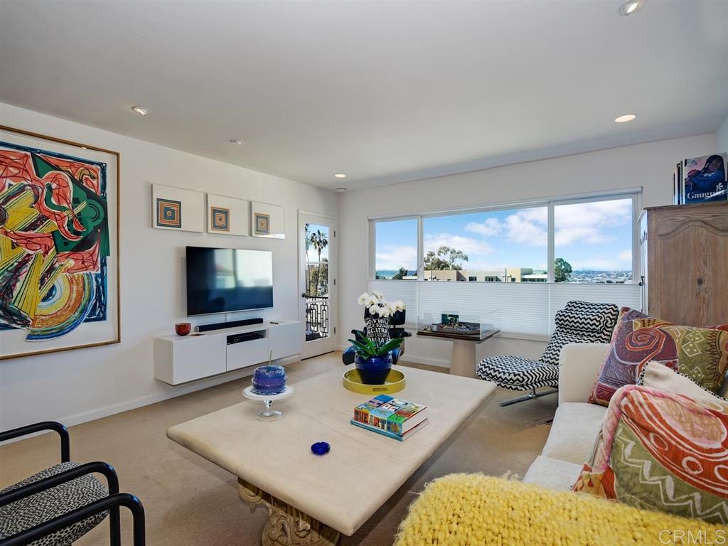 Spacious living room features custom lighting, City and Bay views and pass through to the gourmet kitchen.