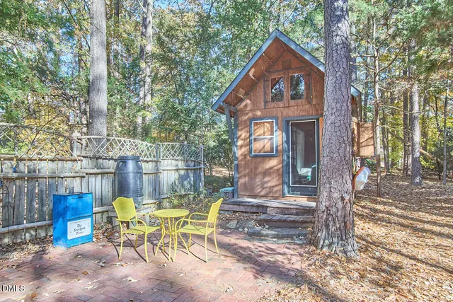 a view of a house with backyard and sitting area