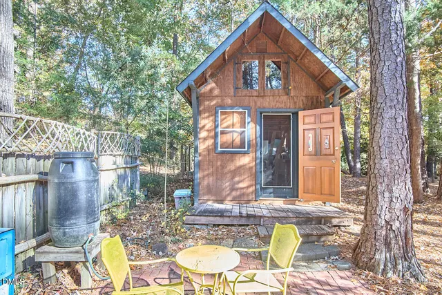 a front view of a house with outdoor seating