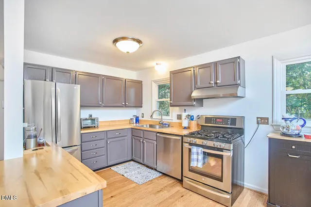a dining room with furniture a chandelier and wooden floor