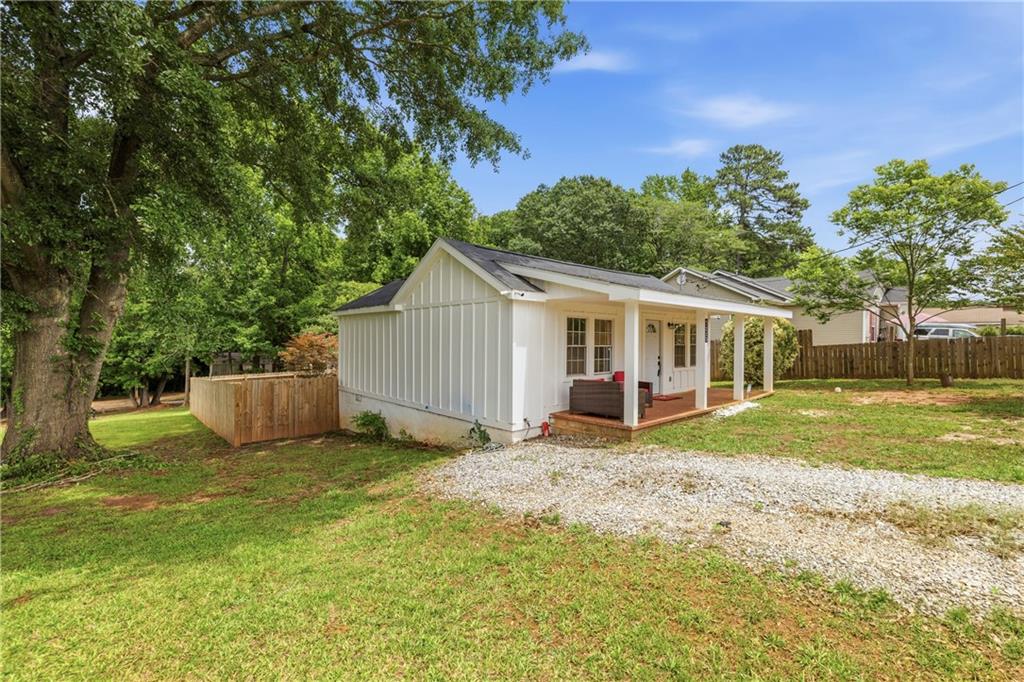 156 Pine Avenue Commerce, GA 30529 - Photo 33 of 35 a view of a house with backyard and a tree