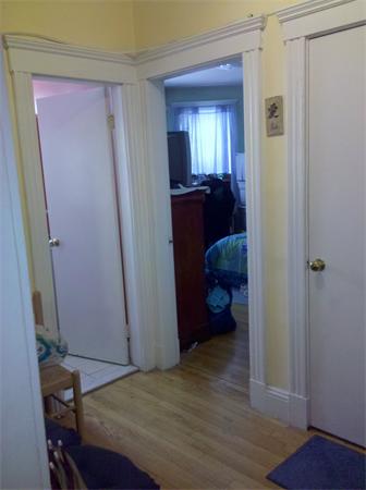 2 Sutherland Road, Unit 22 Boston, MA 02135 - Photo 3 of 4 a bedroom with a bed and a mirror