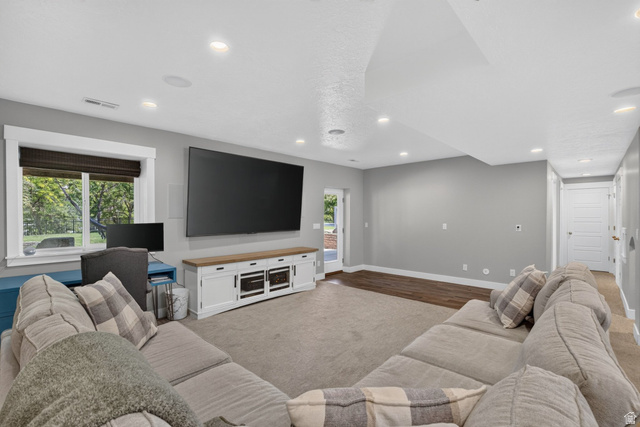 1263 East 1200th South Springville, UT 84663 - Photo 37 of 60 Spacious entertainment room featuring recessed lighting, a large window with white trim, and a built-in media console