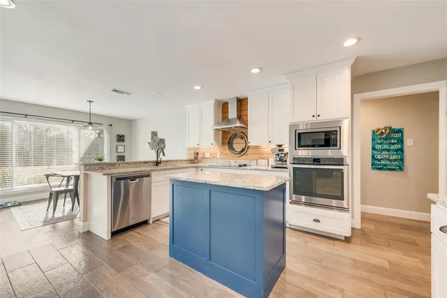 a kitchen with counter top space cabinets and stainless steel appliances