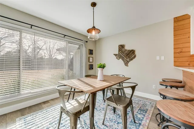 a kitchen with granite countertop white cabinets and stainless steel appliances