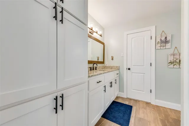a bedroom with a bed dresser and flat screen tv