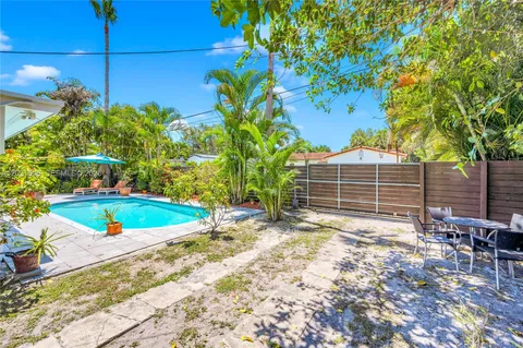 a view of a backyard with plants and a patio