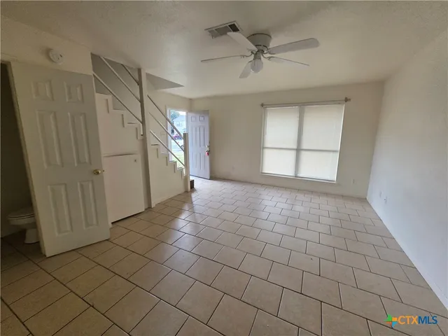a view of an empty room and a window