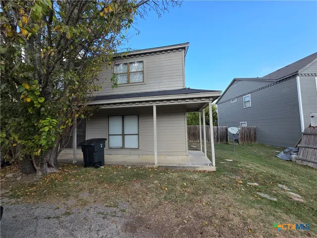 a house that has a tree in front of it