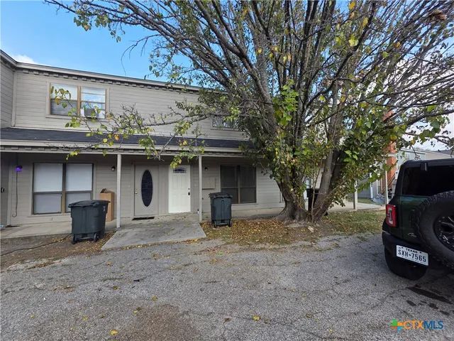 a view of a car park in front of house