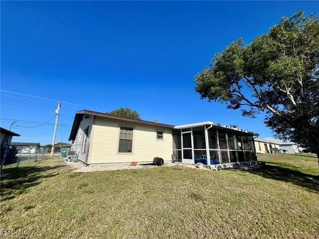 a view of a house with a backyard