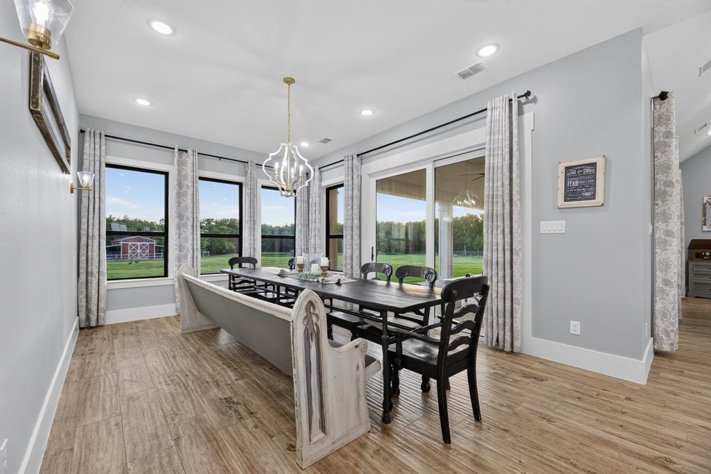 985 Vest Lane Pilot Point, TX 76258 - Photo 28 of 40 Bright dining area featuring wood-finish flooring and light gray walls