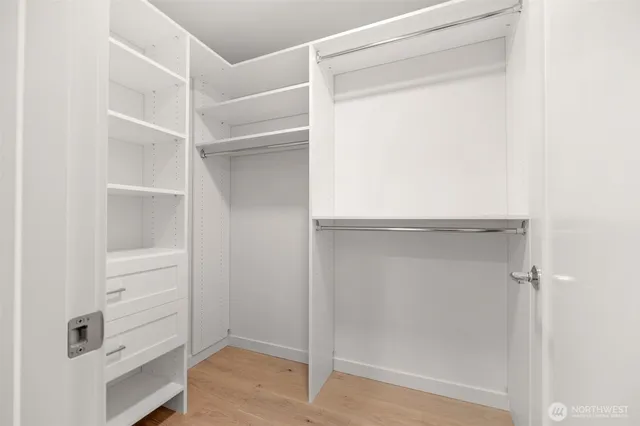 a bedroom with a bed and painting on the wall