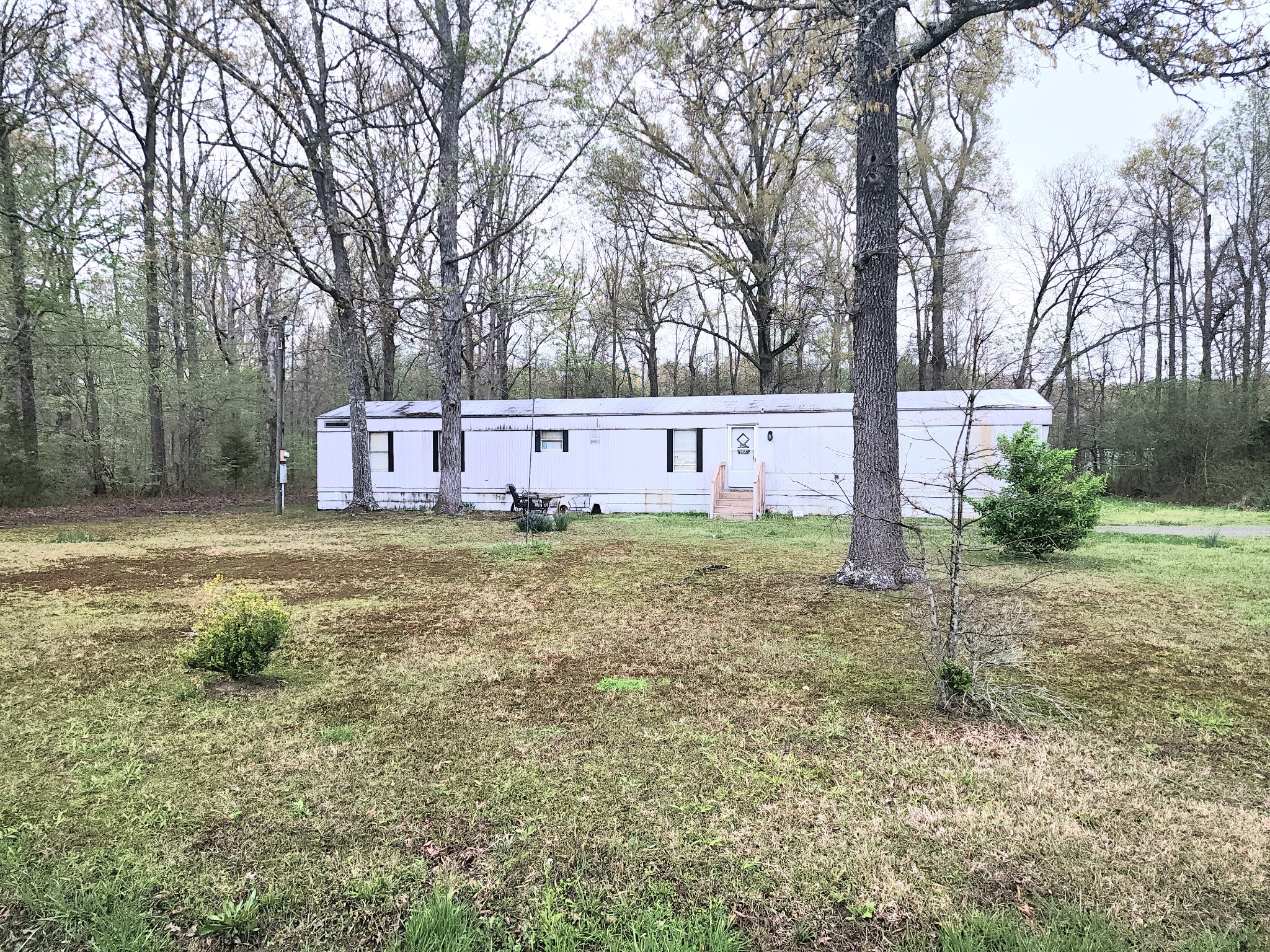 97 Lloyd Boynton Road Manchester, TN 37355 - Photo 1 of 2 a view of a backyard with large trees