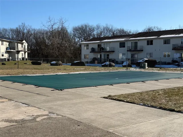 a front view of house with yard and trees in the background
