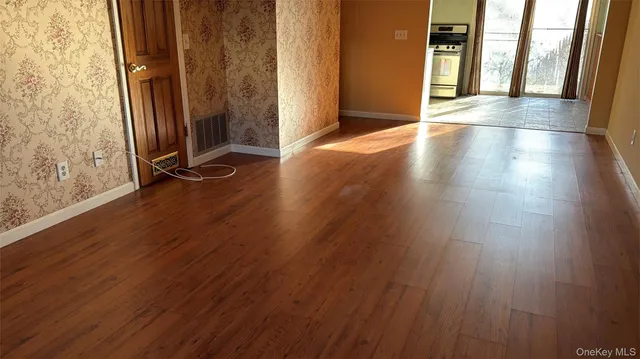 an entryway of a house with wooden floor