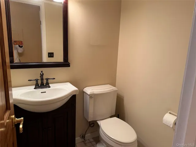 a bathroom with a sink a toilet and mirror