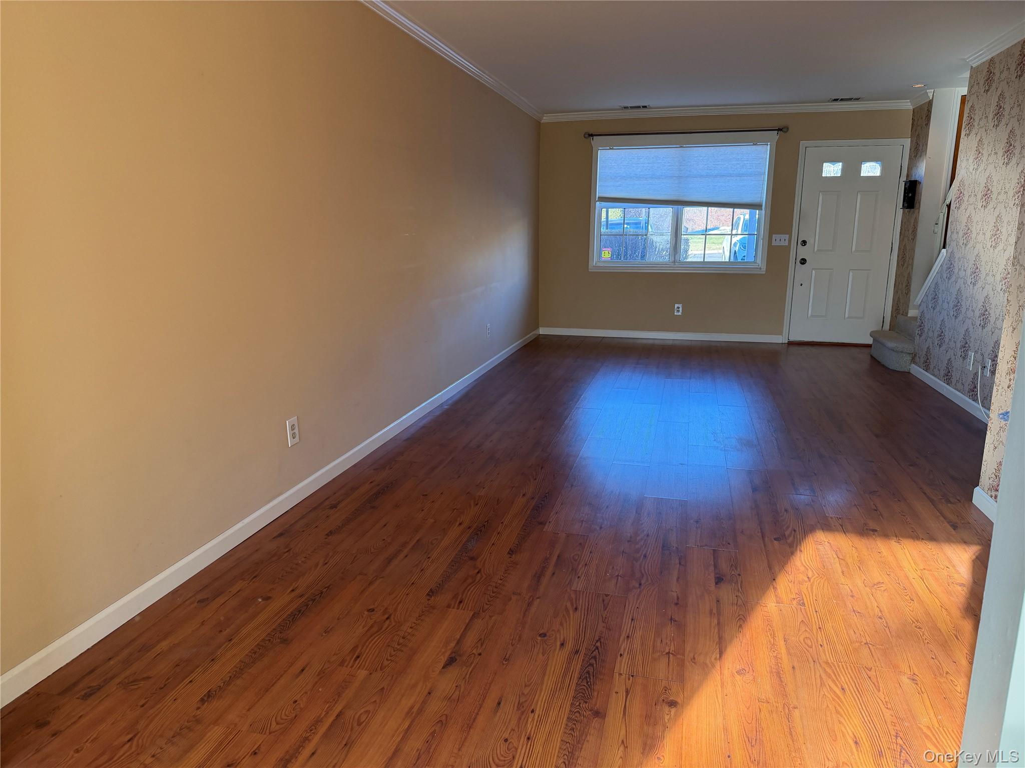 276 Temple Hill Road, Unit 1704 New Windsor, NY 12553 - Photo 7 of 22 an empty room with wooden floor and windows