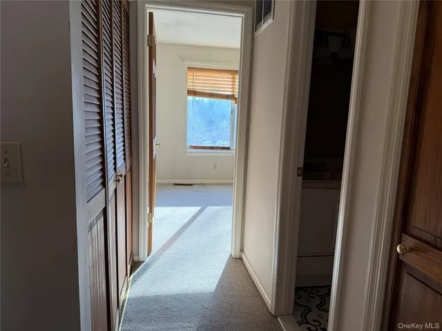 a view of a bathroom from a corridor