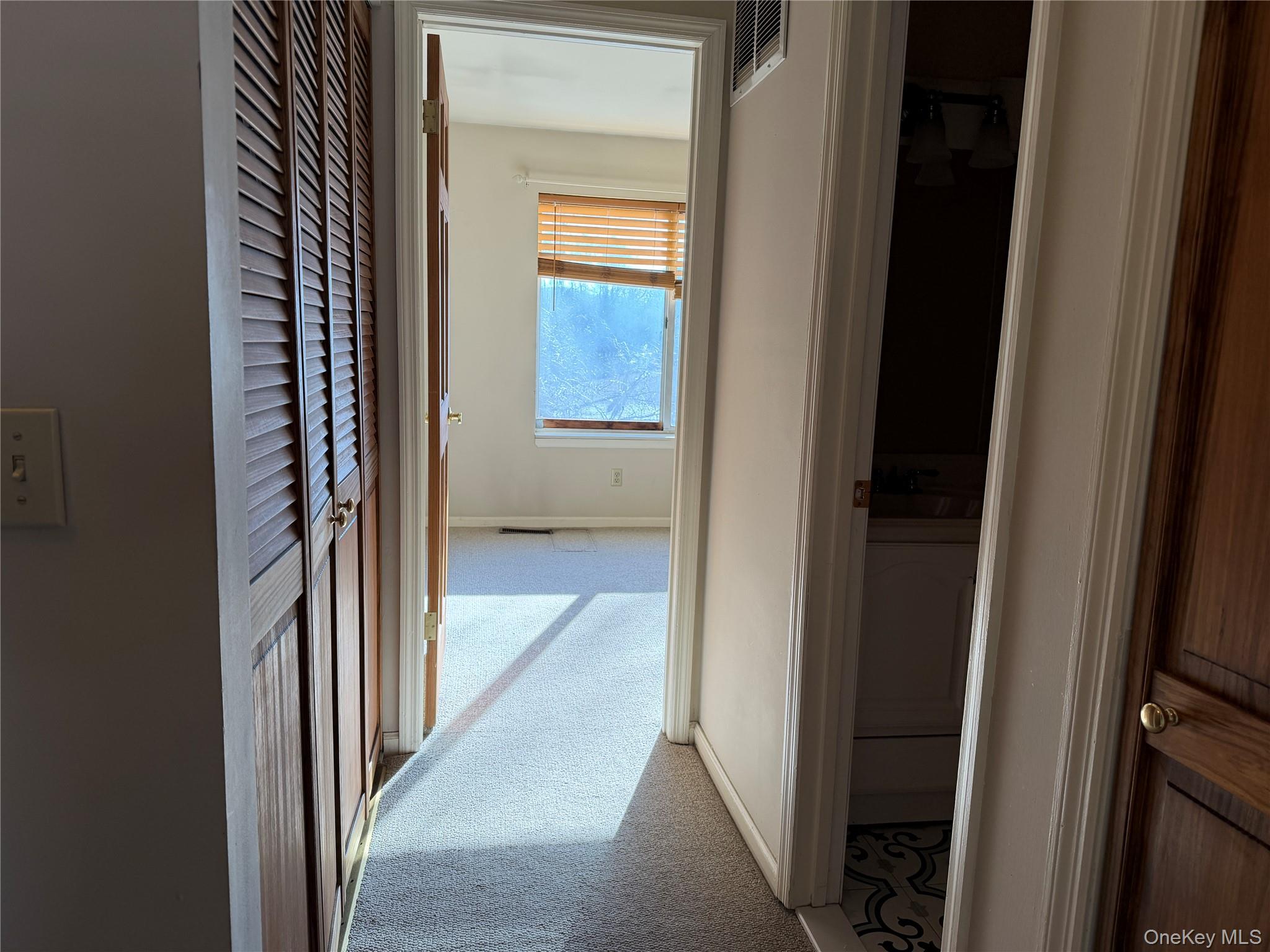 276 Temple Hill Road, Unit 1704 New Windsor, NY 12553 - Photo 10 of 22 a view of a bathroom from a corridor