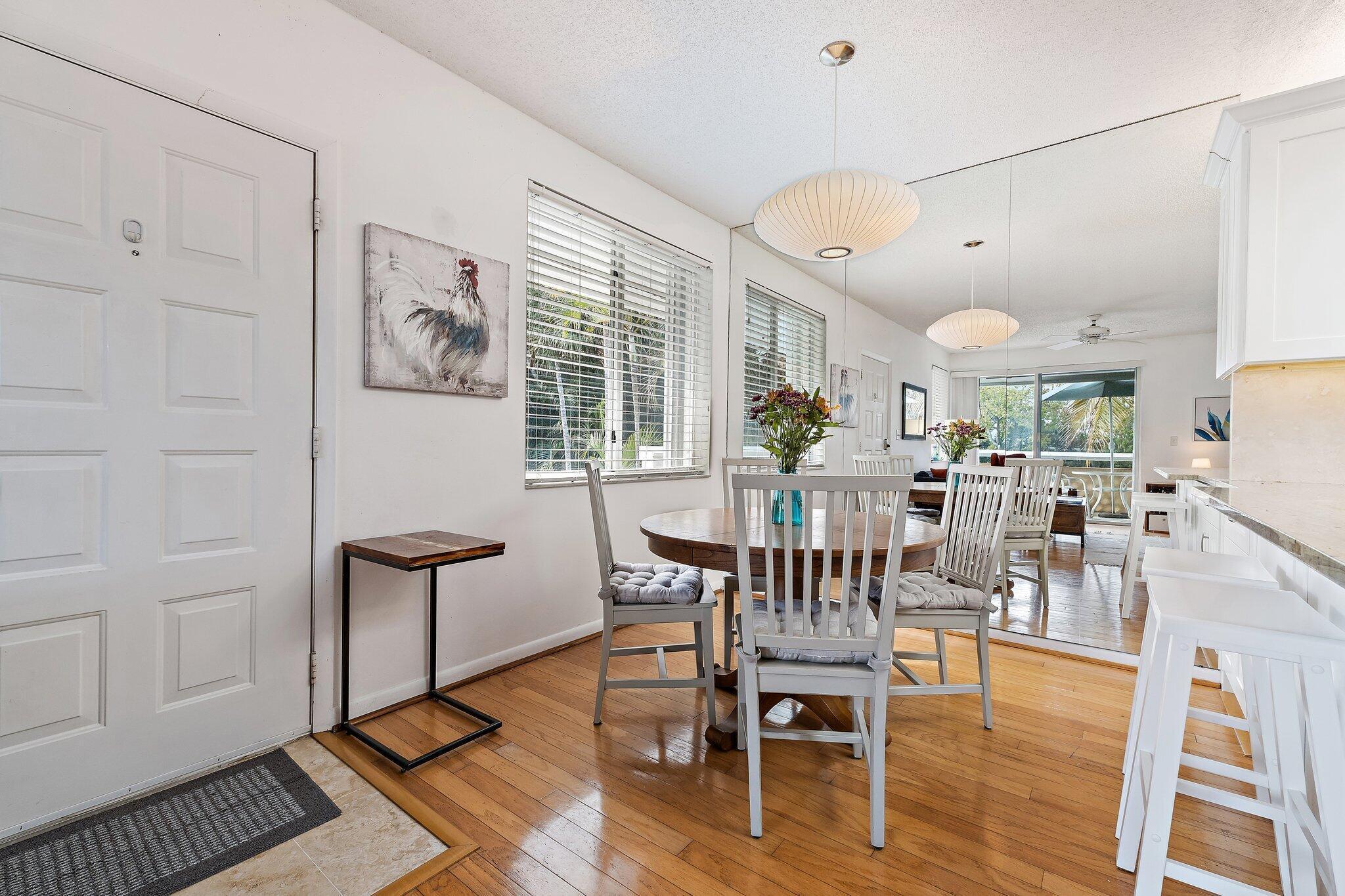 353 Highway 1, Unit C7 Jupiter, FL 33477 - Photo 2 of 45 a view of a dining room with furniture and wooden floor