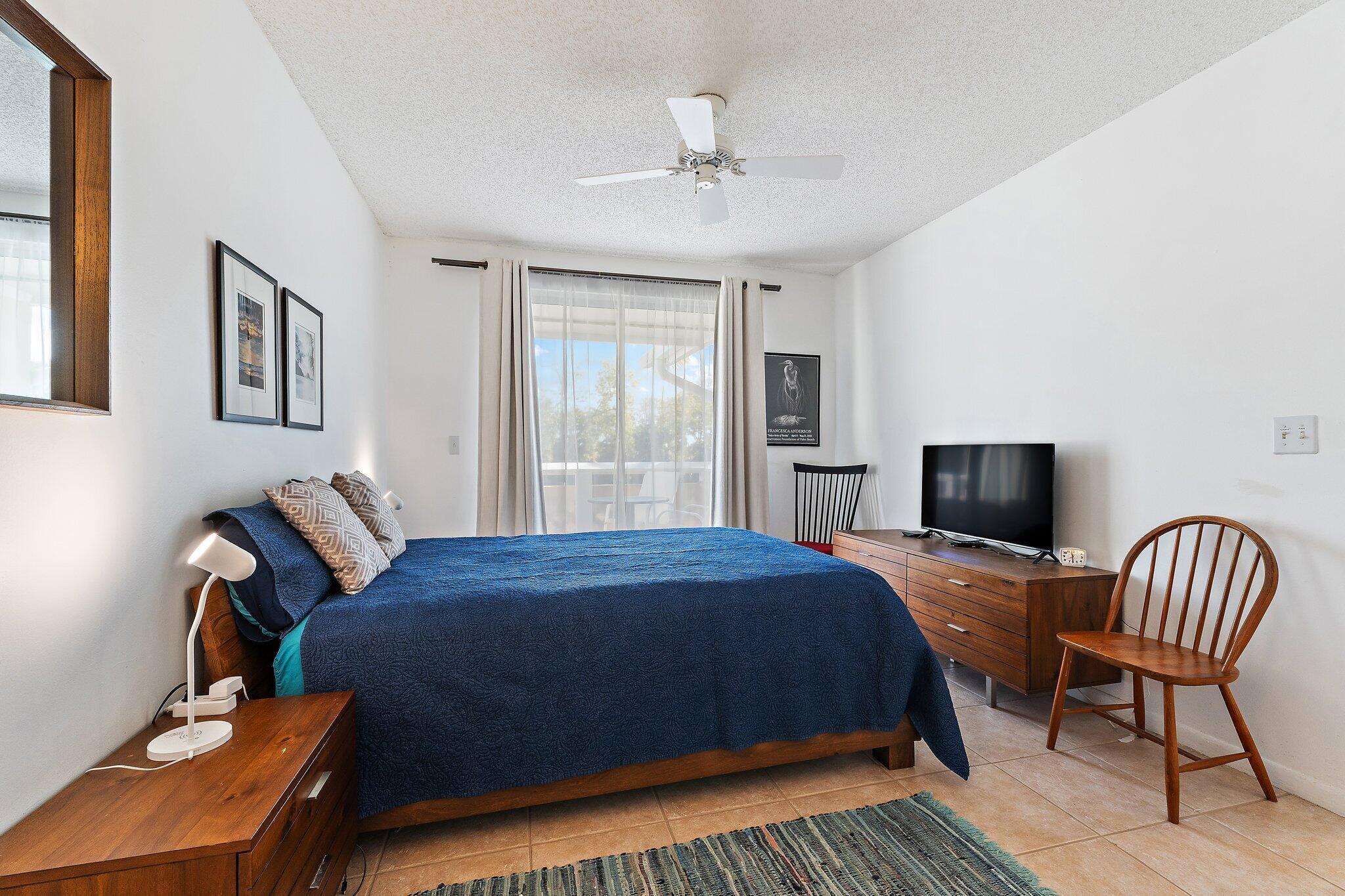 353 Highway 1, Unit C7 Jupiter, FL 33477 - Photo 22 of 45 a bedroom with a bed chair and a window